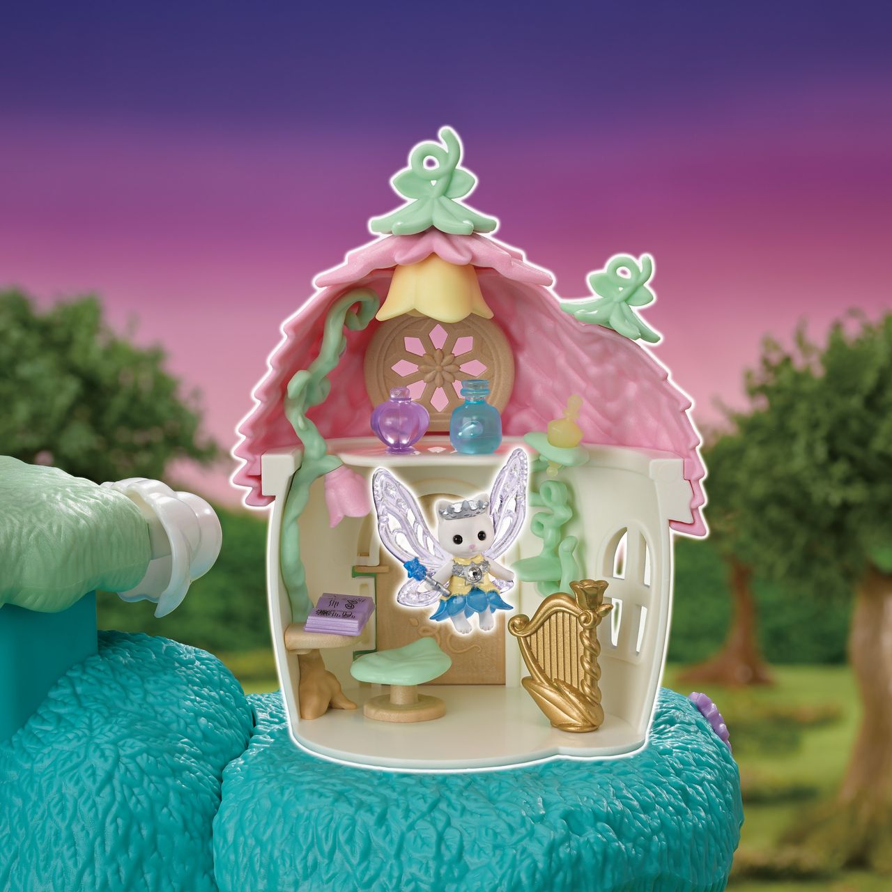 Create your own enchanting fairy forest with the Calico Critters Woodland Wonder Fairy Castle—a charming set featuring a small fairy castle, a fairy figure, magical furniture, and a harp, all set against a vibrant fantasy backdrop of trees and a purple sky. Perfect for imaginative play with delightful fairy accessories!.