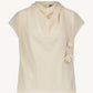 The Lela Rose Drop Flower Cowl Neck Top features a sleeveless cream crepe design with a cowl neckline and elegant drop flower accents at the neck.
