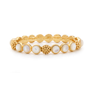 The Berry Gem Hinged Bangle by Juliska Capucine De Wulf features round white gem-drops in bezel settings and textured golden berry accents evenly spaced along the band.