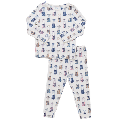 The Pink Chicken Kids' Bamboo PJ Set features a white long sleeve top and pants with colorful eyeglass prints in blue, pink, and brown. Crafted from soft bamboo for ultimate comfort.