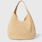 The Stella McCartney Logo Raffia Slouchy Large Tote Bag features a rounded, structured shape and a single wide handle, shown against a plain white background.