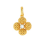 The Juliska Capucine De Wulf Berry Clover Double Sided Pendant features a gold flower design with textured petals, a smooth white center, and a twisted loop for easy attachment—crafted as a lucky charm.