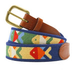 The Smathers & Branson Pompano Belt by Smathers & Branson is a brown leather belt showcasing colorful fish shapes embroidered on a blue fabric band and featuring a brass buckle. Crafted from vegetable-tanned Italian leather, this hand-stitched traditional belt exemplifies exquisite attention to detail and timeless style.