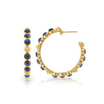The Berry Gem Medium Hoop Earrings by Juliska Capucine De Wulf feature round blue stones and gold bead accents, showcased from side and front views on a white background—a timeless piece for any feminine jewelry collection.