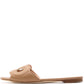 The Lido Sandal by Rupert Sanderson is a handmade Italian flat slide in tan Cremino Calf, featuring an open toe, low wooden heel, and a gold accent on the upper strap.