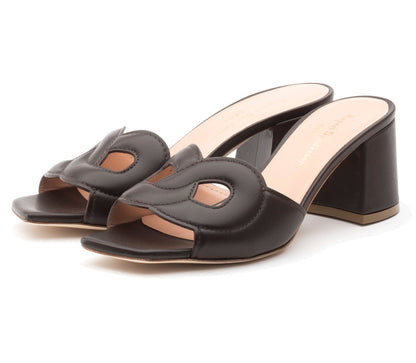 The Laguna Heel by Rupert Sanderson is a black open-toe mule with cutout upper detailing and a block heel, handmade in Italy.