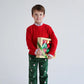 A young boy in a red sweater and The Beaufort Bonnet Company Boys' Critter Prep School Corduroy Pant holds a box of Christmas lights while standing against a plain white background.