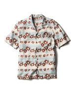 The Breeze Camp Shirt by Faherty is a short-sleeve button-up featuring light blue and white stripes, a brown floral pattern, and a chest pocket on the left side.
