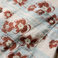 Close-up of the Faherty Breeze Camp Shirt in light blue and white plaid with brown and white floral patterns, featuring a visible chest pocket.