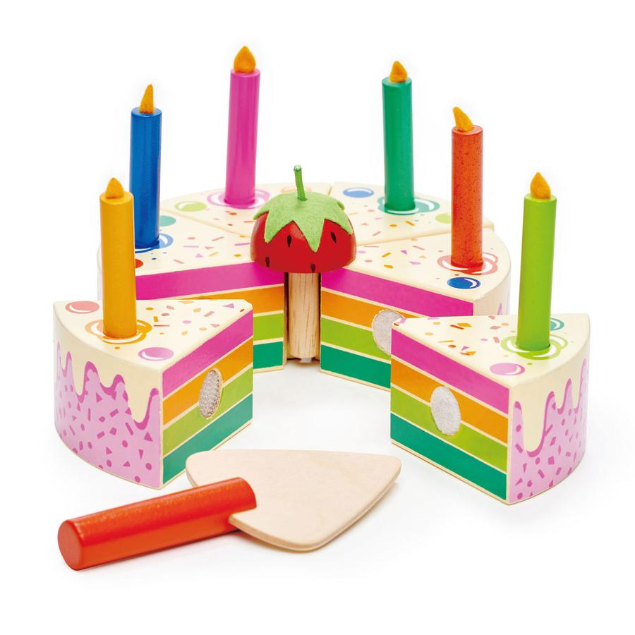 A Tenderleaf Rainbow Birthday Cake from Tender Leaf Toys sits on a wooden rainbow birthday cake stand, ready to be cut with a knife.