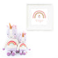 Two Cuddle + Kind Zoe the Unicorn - Little 13" dolls, with rainbow details, sit next to a framed print of a unicorn and rainbow with "Everything she does is magic," creating an enchanting display.