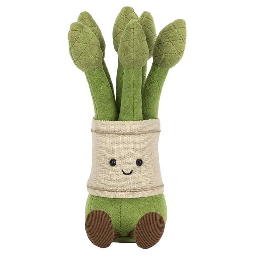 The Jellycat Amuseables Asparagus is a plush toy shaped like a bunch of green asparagus stalks, featuring stitched eyes, a smiling mouth, and little brown feet.