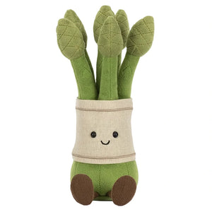 The Jellycat Amuseables Asparagus is a plush toy shaped like a bunch of green asparagus stalks, featuring stitched eyes, a smiling mouth, and little brown feet.