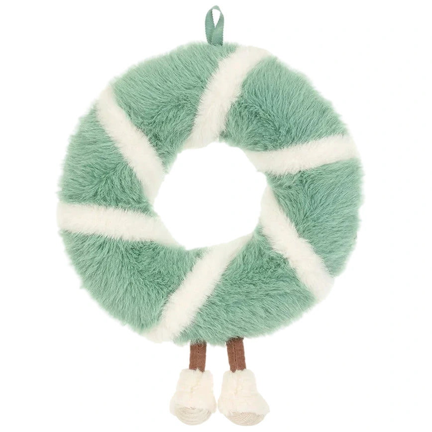 A Jellycat Amuseables Pinecone Wreath with soft green and white segments, dangling brown legs with white boots, and a ribbon loop for hanging.
