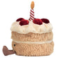 The Jellycat Amuseables Birthday Cake is a plush toy shaped like a colorful cake, with red cherries, cream, a striped candle on top, and a small brown tail—perfect for any birthday celebration.
