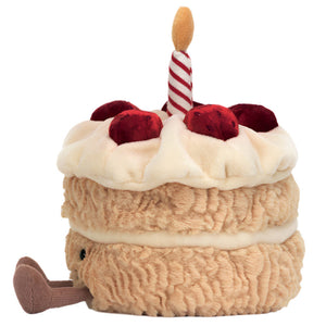 The Jellycat Amuseables Birthday Cake is a plush toy shaped like a colorful cake, with red cherries, cream, a striped candle on top, and a small brown tail—perfect for any birthday celebration.