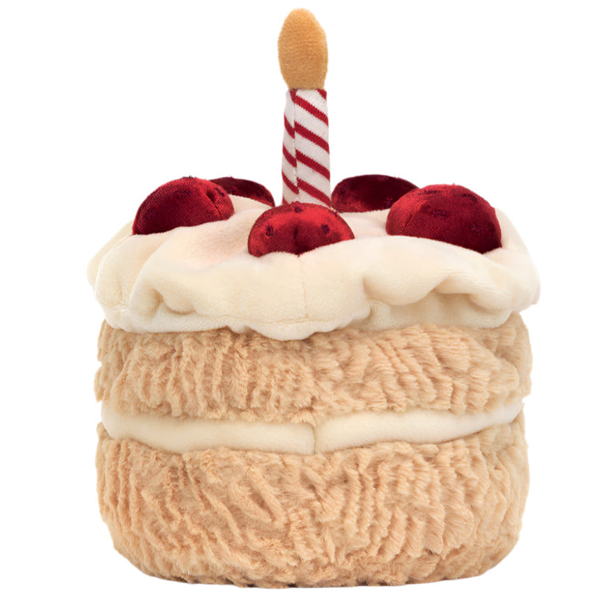 The Jellycat Amuseables Birthday Cake is a plush toy shaped like a colorful layered cake with white icing, red cherries, and a red-and-white striped candle—perfect for any birthday celebration.