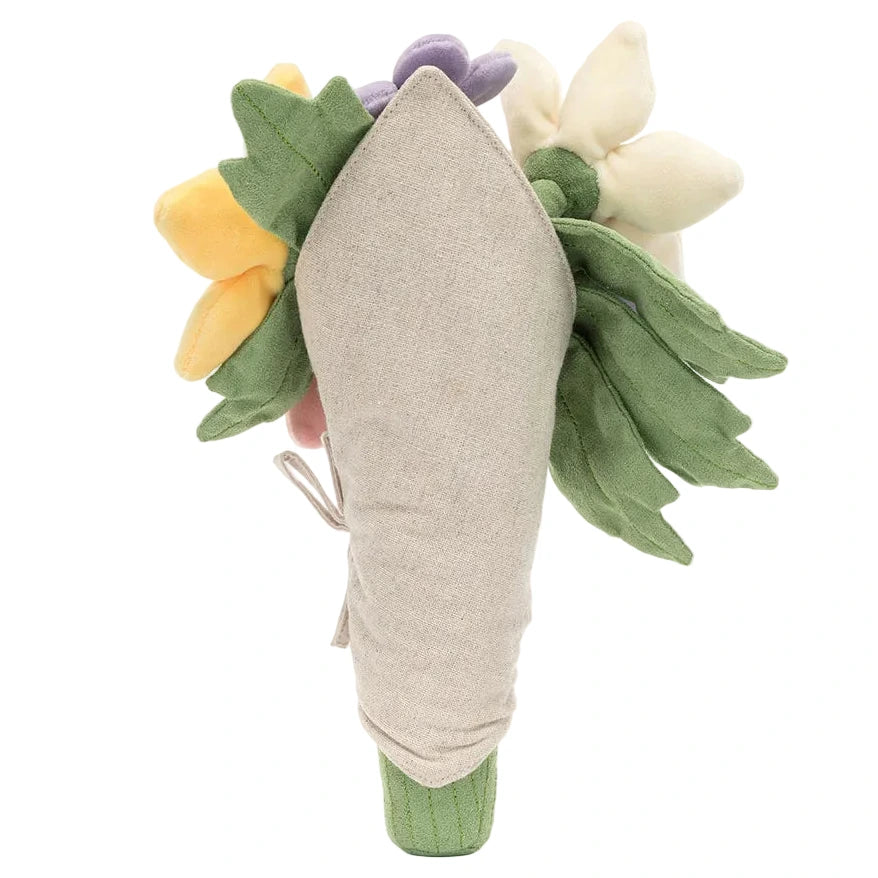 A Jellycat Amuseables Bouquet of Flowers featuring yellow, purple, and cream-colored flower heads with green leaves, wrapped in tan fabric.