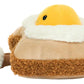 The Jellycat Amuseables Egglantine Egg on Toast is a plush toy resembling a slice of toast topped with a yellow chick face and a fluffy white edge, shown against a white background.