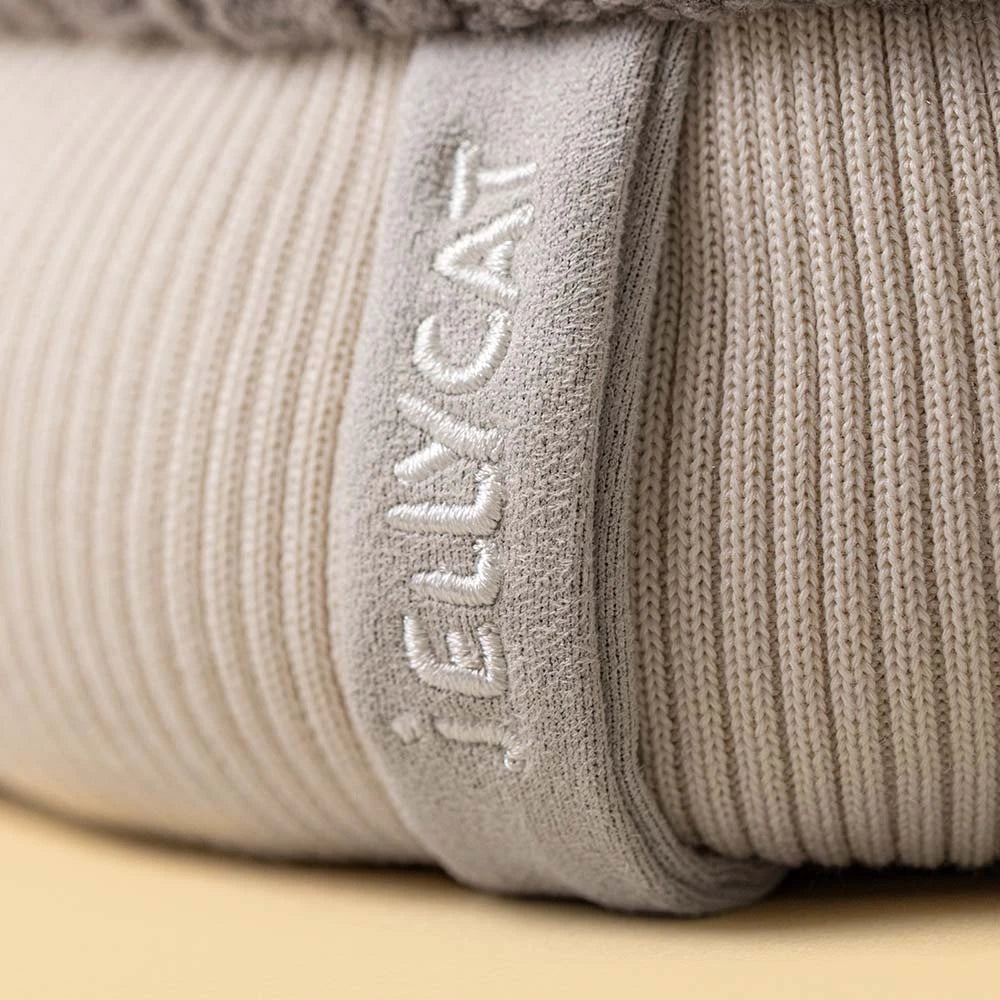 Close-up of a beige ribbed fabric with a soft “Jellycat” tag—ideal for gifting or adding to your Amuseables Pomilly collection.