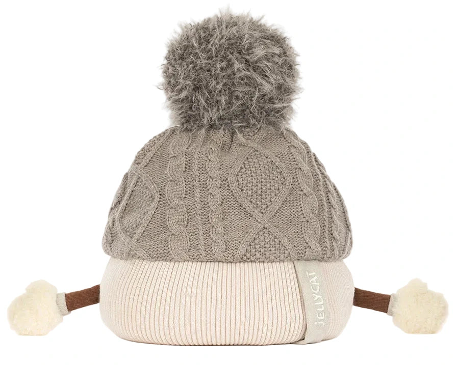 The Amuseables Pomilly by Jellycat is a knit beige and gray hat with cable pattern, big pom-pom, side ties, and white pom-poms—perfect for a cozy Christmas party!.