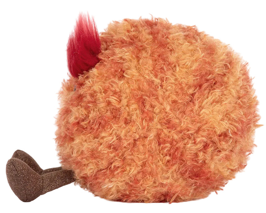The Jellycat Amuseables Planet Mars is a round, fluffy orange plush toy with a red tuft and two brown feet, shown from the side on a white background.