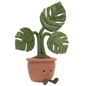 The Jellycat Amuseables Monstera Plant is a plush toy with green leaves, a brown terracotta pot, and a smiling face with legs—an adorable office plant alternative.