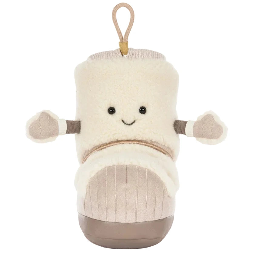 The Amuseables Perta Snow Boot by Jellycat is a cozy beige boot plush with a smile, arms, and loop—perfect for Christmas decor or gifting.