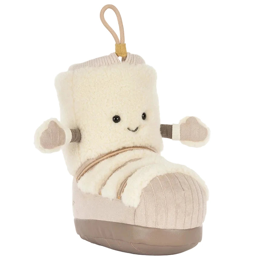 Add festive charm to your decor with the Jellycat Amuseables Perta Snow Boot—a plush toy shaped like a smiling beige boot with arms and a loop handle.