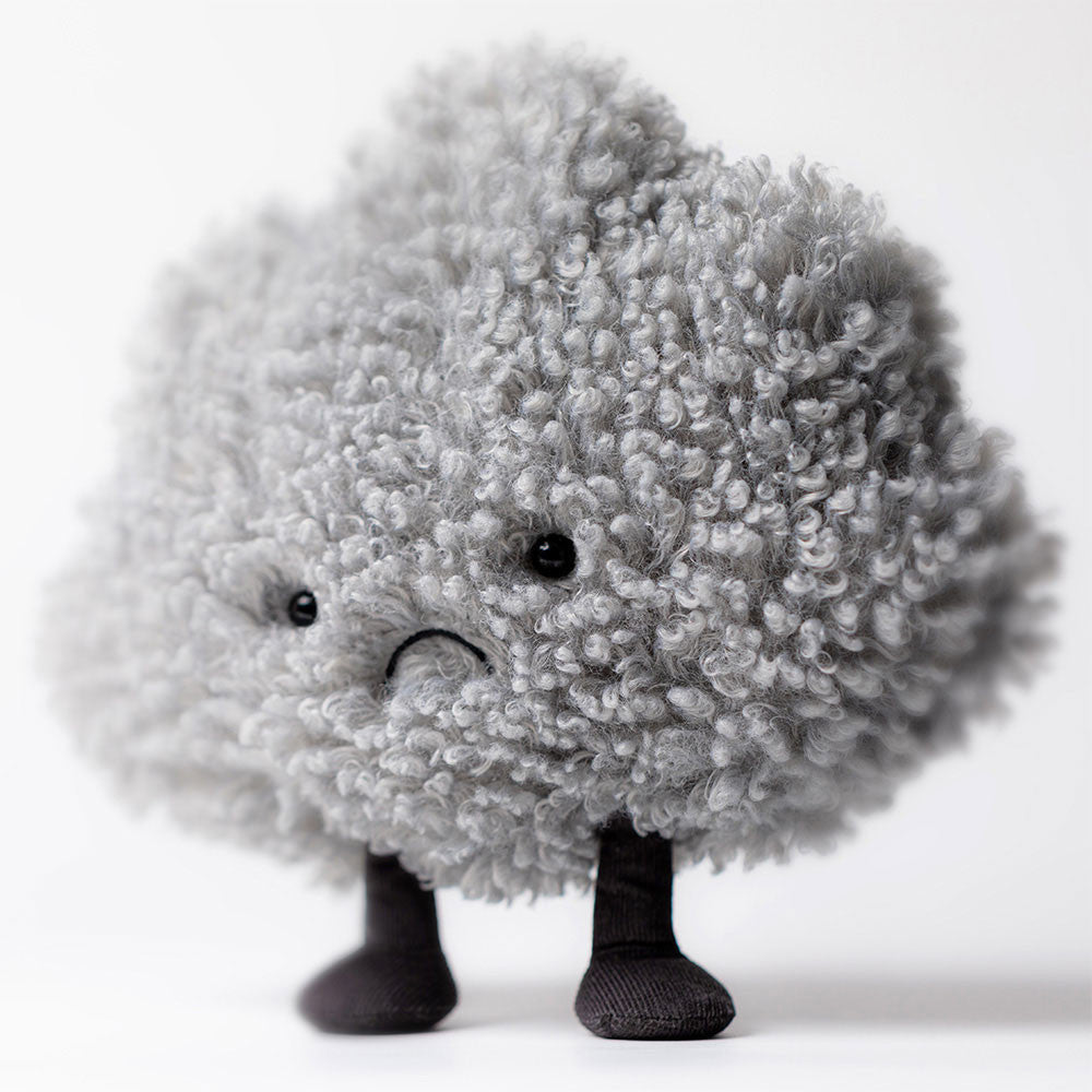 The Jellycat Amuseables Storm Cloud is a plush toy shaped like a fluffy gray cloud with a sad face and short legs, making it a unique and adorable gift for cuddly toy lovers.