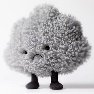 The Jellycat Amuseables Storm Cloud is a plush toy shaped like a fluffy gray cloud with a sad face and short legs, making it a unique and adorable gift for cuddly toy lovers.