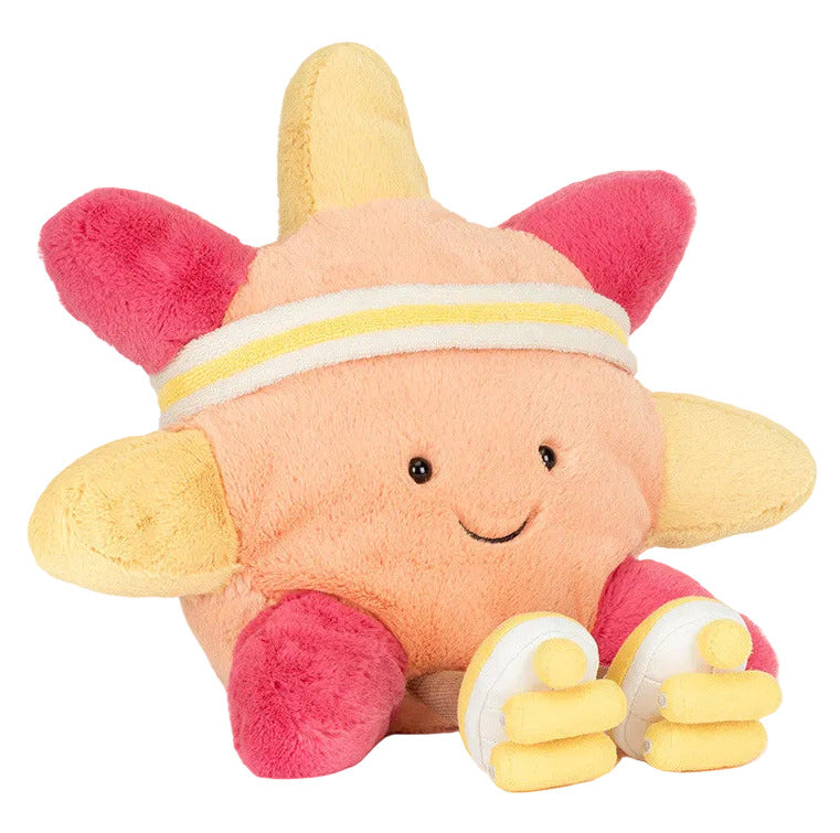The Jellycat Amuseables Sun 'Roller Skates' is a cheerful plush toy shaped like a smiling sun, with pink and yellow rays, white headband, and yellow-and-white roller skates—perfect for sunny boardwalk adventures.