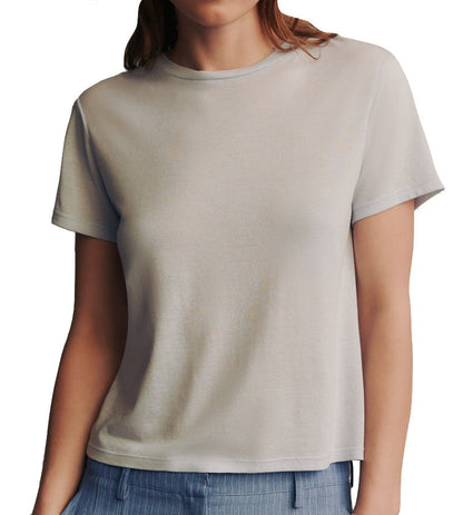 Woman wearing a plain light gray TWP His Tee, cropped at the neck, on a white background.