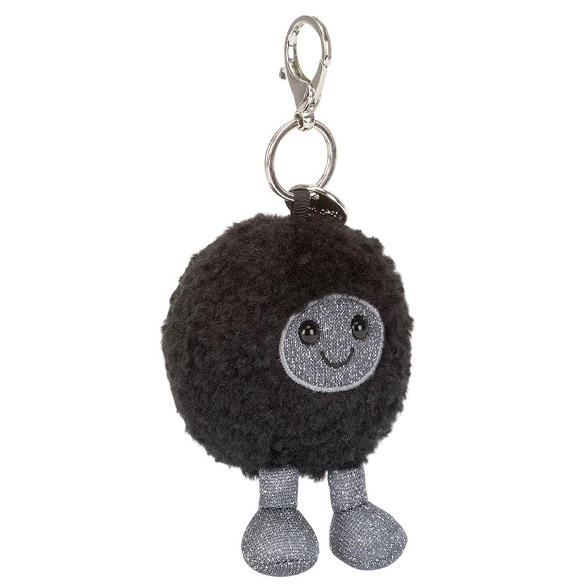 The Amuseables Black Hole Bag Charm by Jellycat is a round, black, fluffy bag charm with a smiling gray face and legs, attached to a silver keyring and clasp—a playful accessory for any fan.