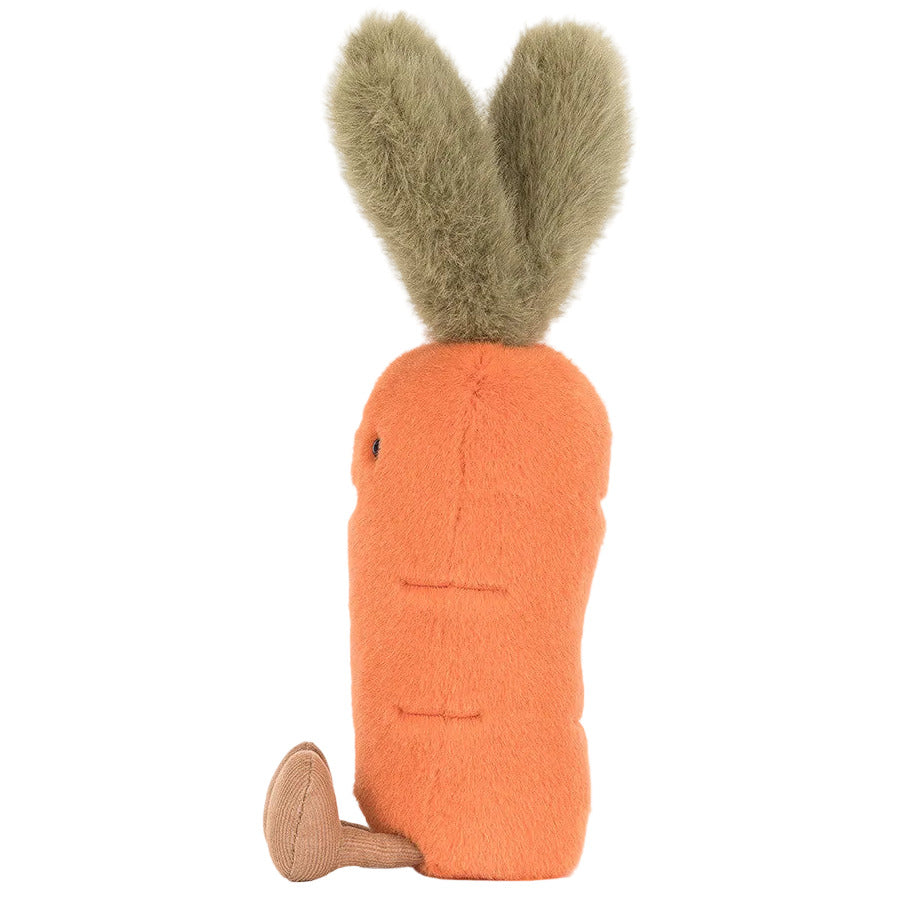 The Jellycat Amuseables Carrot is a plush toy shaped like an orange carrot, featuring two green, furry leaves on top and a small brown root at the base.