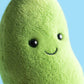 Close-up of the Jellycat Amuseables Soyella Edamame Bean plush toy, featuring a green bean shape with black button eyes and a stitched smile, set against a blue background.