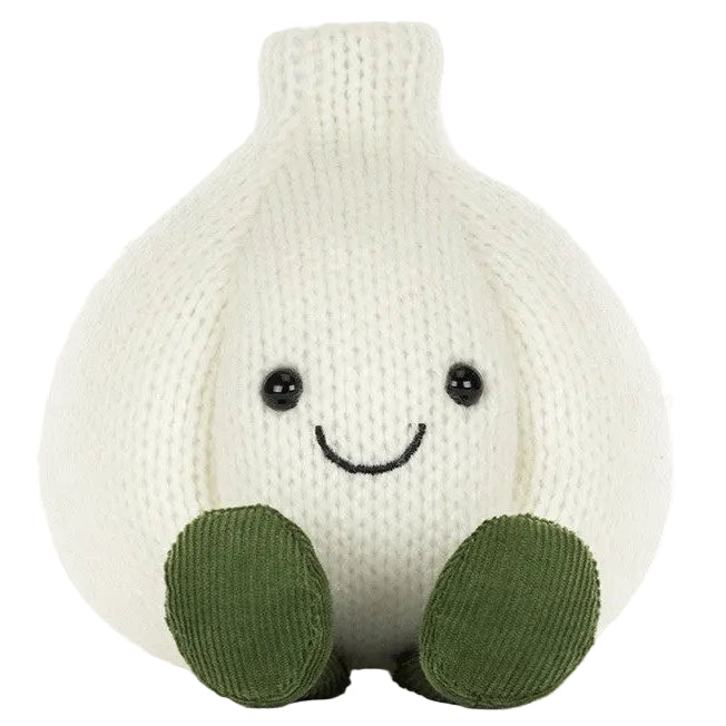 A Jellycat Amuseables Garlic plush, featuring a knitted white garlic bulb design with black eyes, a smiling mouth, and green feet, sits upright against a white background—an ideal quirky accent for your Halloween party décor.