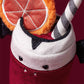 The Jellycat Amuseables Vampop Drink is a whimsical Halloween plush from Jellycat, designed as a cup with felt fangs, bat wings, a citrus slice decoration, and a striped straw—making it the perfect addition to your seasonal decor.