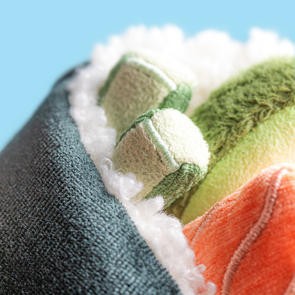 Close-up of Jellycat's Amuseables Coneroi Temaki plush, designed to resemble a sushi roll with soft green, orange, and white fabric—ideal for party planners or event coordinators seeking adorable sushi-themed decor.