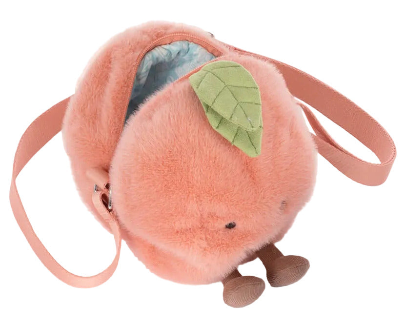 The Jellycat Amuseables Peach Shoulder Bag is a plush, peach-shaped bag with a green leaf, pink strap, small brown legs, and an open zipper.