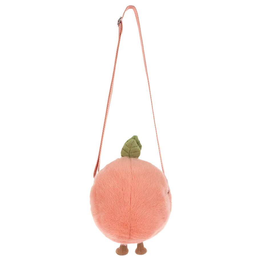 The Jellycat Amuseables Peach Shoulder Bag features a green leaf on top, small brown feet at the bottom, and a pink shoulder strap.