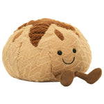 Amuseables Sourdough by Jellycat is a cute plush toy shaped like round bread with a smile and little legs, made from light and dark brown fabric—an adorable gift for any occasion.