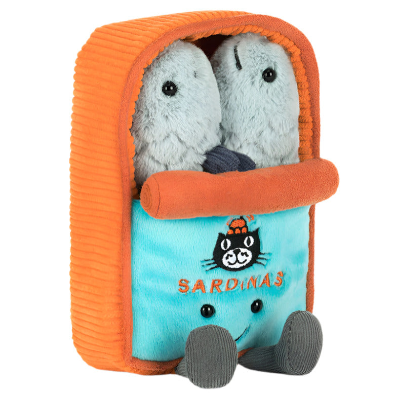 Two plush sardines cuddle inside a soft blue and orange tin with "SARDINAS" and a cartoon cat face embroidered on the front. Shop the Jellycat Amuseables Sardine Tin at Swinley Boar's Boar Store!.