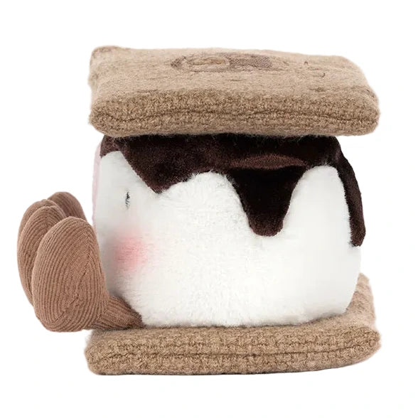 Meet Amuseables S'mores by Jellycat—a plush toy shaped like a s'more with a white marshmallow center, brown chocolate top, tan graham cracker sides, and an adorable face with blushing cheeks!.