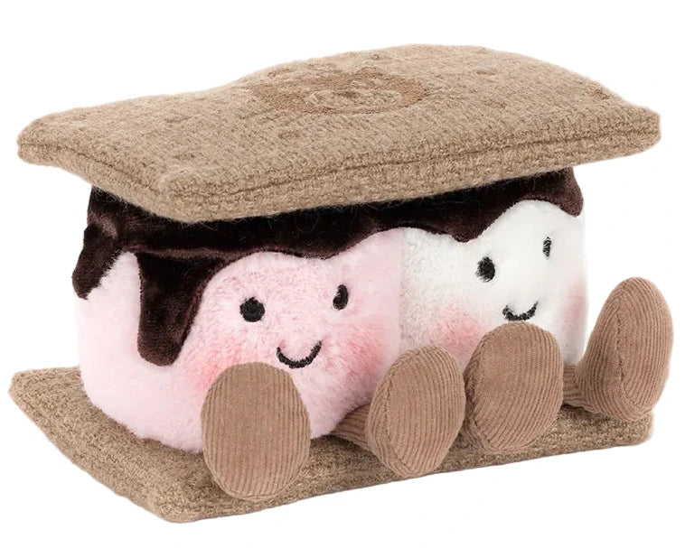 The Jellycat Amuseables S'mores is a plush shaped like a s'more, with two smiling marshmallows featuring pink cheeks, chocolate, and graham cracker pieces on the top and bottom.