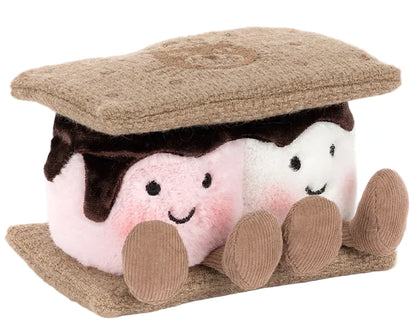 The Jellycat Amuseables S'mores is a plush shaped like a s'more, with two smiling marshmallows featuring pink cheeks, chocolate, and graham cracker pieces on the top and bottom.