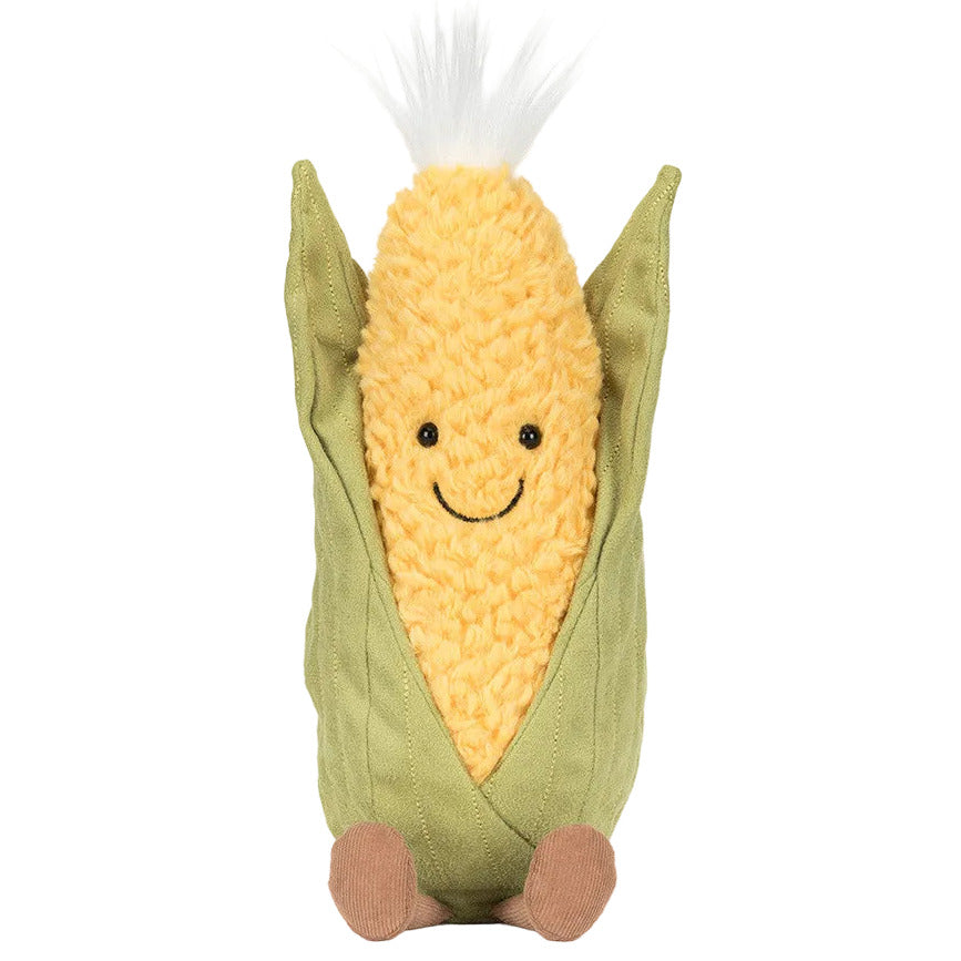 The Jellycat Amuseables Sweetcorn is a plush toy shaped like an ear of corn with a smiling face, brown feet, a green husk, and a white tuft on top.