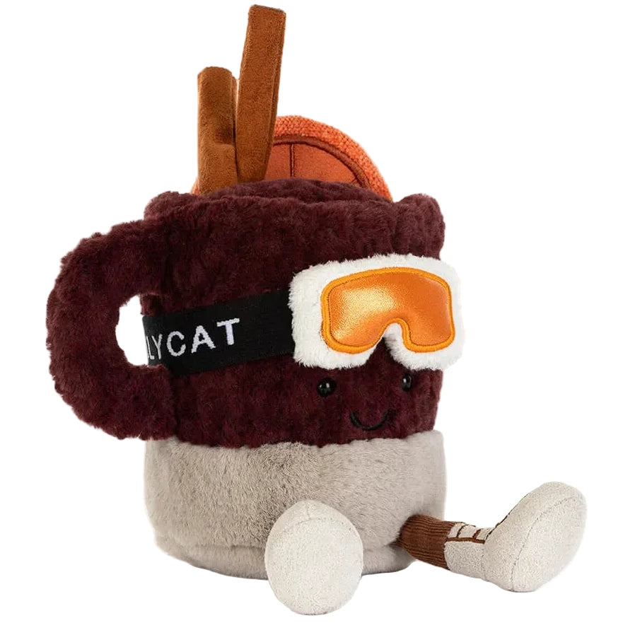 Jellycat’s Amuseables Mullover Spiced Drink is a plush mug with orange ski goggles, skis, cinnamon sticks, and a smiling face.