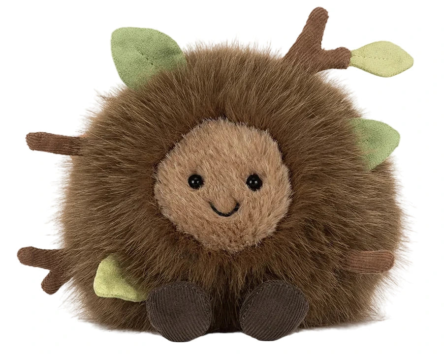 Meet the adorable Jellycat Amuseables Mulshi Woodland Floor, a plush toy shaped like a fluffy brown ball with a smiling face, brown feet, and soft fabric branches with green leaves inspired by the woodland floor.