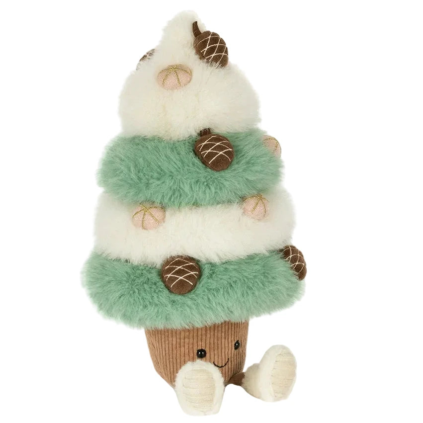 Jellycat Amuseables Pinecone Tree plush with tiered, alternating green and white fuzzy branches decorated with small acorns, sitting on a brown corduroy base with two dangling legs and a smiling face.